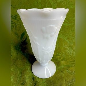 Milk glass vintage vase. Flowers adorn the outside.